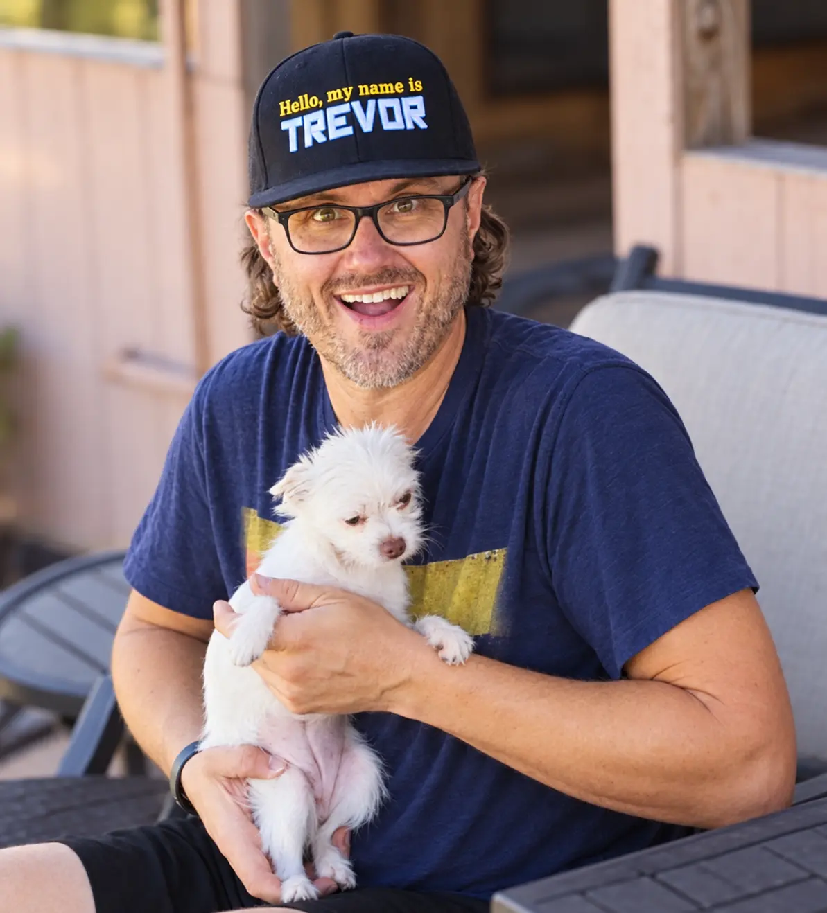 Trevor W. Chevalier smiling while holding one of his dogs